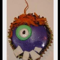 One-Eyed Purple People Eater cupcake with fondant decoration. 'hair' is coconut dyed orange