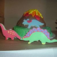 Volcano Cake With Dinosaur Cookies A volcano cake with dinosaur cookies.