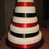 Wedding Cake white fondant w/ satin ribbon, my first big cake, made for my sisters wedding.