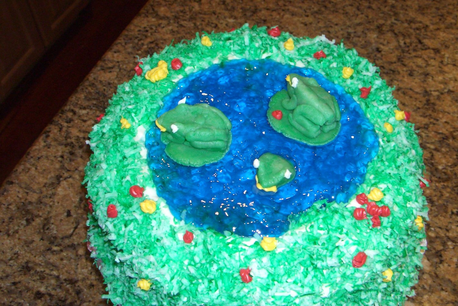 Cimg4049.jpg A pond cake made by me and my friend, both ninth graders , for my sister's birthday. The pond is made of jello, frogs out of almond...
