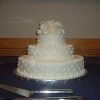 My First Wedding Cake Thanks to the forums this cake went smoothly. I was well prepared and knew exactly what to do. The bow on top is made of fondant. Enjoy!