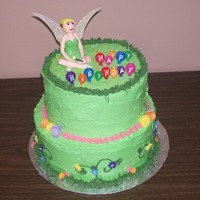 Tinkerbell Chocolate and vanilla layered cake, with vanilla buttercream frosting, Flowers are fondant. Tinkerbell is fondant with a little CMC. Tink&#...