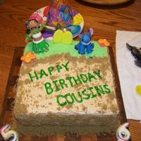 Lilo & Stitch Chocolate cake with vanilla frosting. Fondant figures and brown sugar sand! For my son and my nephews birthday! The boys loved it!!