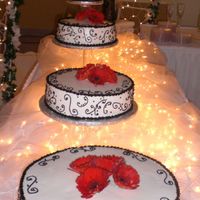 Red, Black, And White Wedding Cake The bride wanted black scrolls. The red came from the live daisies.