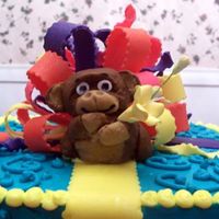 Monkey-Detail I made this for my daughter's 9th birthday. The cake is frosted with butter-cream w/a fondant monkey and bow. This was my first try...
