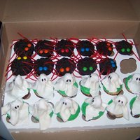 Halloween Ghost Cupcakes Spiders are triple chocolate fudge with peanut butter icing. The ghost are vanilla with orange icing for the ghost I used a tootsie pop and...