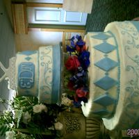 Blue Diamonds And Scrolls This is the first official wedding cake I made and I think it turned out ok. I had some trouble with the fondant ribbons and I wish the...