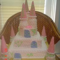 Castle Cake All buttercream frosting. Brick effect done freehand with flat side of basketweave tip. Towers are buttercream frosted wafer cones on...