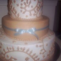 Cornflower Blue All buttercream wedding cake with a cornflower blue ribbon around the middle tier.