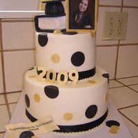 Graduation Black And Gold Two Tier Graduation Cake with black and gold accents and book.