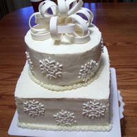 Winter Snowflake Cake. The snowflakes are royal icing and the bow is gumpaste.