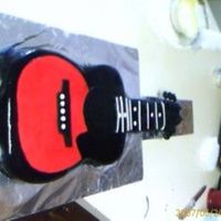 Guitar Cake I did this for my boss. His son plays guitar and was coming home from college. THis was my first commissioned cake.