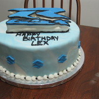 Sportbike/suzuki Theme Birthday Cake First cake carving experience, marshmallow fondant Suzuki symbols around the outer edge.