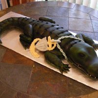 Alligator We made this cake for a friend it was a lot of fun but wow it took forever. Vanilla cake covered in MMF.