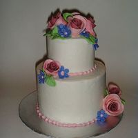 Mini Wedding Cake This little wedding cake serves on 16 people. It is a chocolate cake with buttercream icing and fondant roses.