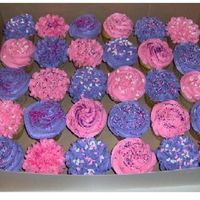 Birthday Cupcakes vanilla cupcakes with pink and purple buttercream with a variety of sprinkles