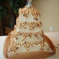 Ivory And Gold This is a Maple cream cake with maple crm cheese icing. The flowers are made out of gum paste and then brushed with two colors of gold...