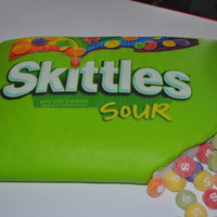 Skittles made for my kids birthday. They wanted skittles. sheet cake covered in fondant with edible image. made cupcakes covered in fondant dipped...