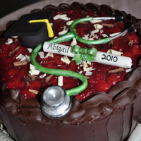 Nursing School Black Forest simple black forest cake. Fresh cherrie filling with whipped cream and ganache. Fondant scroll and stethoscope.
