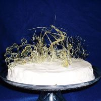 Vanillabean Cheesecake With Spun Sugar The cake is a vanilla bean cheesecake with an abstract design of spun sugar on top. The