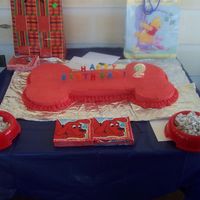 Clifford "bone" Cake White,Chocolate, and Strawberry Cake with BC icing. Puppy Chow in the Dog Bowls.