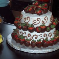 Wedding Shower Cake Bottom layer yellow/with b/c, top is chocolate/with rasberry mousse, iced in b/c with chocolate b/c decoration, accented by chocolate...