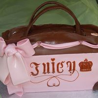 Juicy Purse Four layers of white cake with a filling of fresh strawberries and cream cheese.