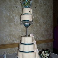 Cream Dream Each tier is decorated in hand molded and cut fondant lace. The pleated drapes matched the bride's dress and the roses matched her...