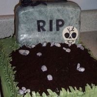 Grave Chocolate sheet bottom with buttercream icing. Tombstone is white cake with strawberry, creamcheese icing and fondant.