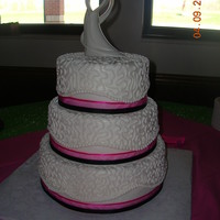 Round Wedding Cake W/lace And Ribbon all buttercream icing with "squiggles" , iced smooth at the bottom and satin ribbon on the bottom of each tier