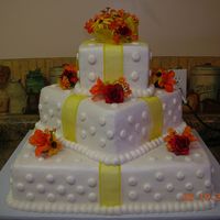 Square "catty" Cornered Wedding Cake All buttercream icing with satin ribbon accents and silk flowers. The cake was chocolate and white cake.