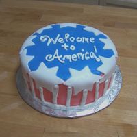 Welcome To America A chocolate cake with raspberry filling. Whipped icing with fondant decorations. Made for a coworker who's uncle was visiting the U.S...