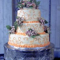 Ivory And Peach Wedding Cake 3 tier buttercream torted with homemade strawberry filling. The flowers on the cake were provided and I thought they really didn't...