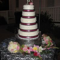 Amanda's Wedding Cake 5 tiered - Buttercream with pink and black ribbon . This was my very first wedding cake that I made for my daughter's wedding.