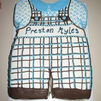 Baby Myles Sheet cake cut in the shape of romper. White cake with chocolate pastry cream filling and buttercream icing.