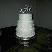 Ashlees_Wedding_Cake_001.jpg White 3-tiered cake with a curly pattern. This was my first time haveing to freehand a design.
