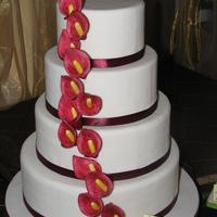 Red Arums anothe cake for the bridal fair. 6,8,10,12". Gumpaste arums I painted. they were a lot darker IRL, almost the same as the ribbon