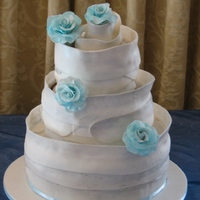 White Wrap Chocolate sponge cake wrapped with chocolate paste. Dusted with silver luster dust. Chocolate paste roses