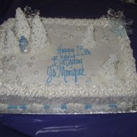 Winter Wonderland Half sheet cake with buttercream frosting. The trees are ice cream cones with royal icing. The snowman is fondant.