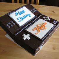 Nintendo Ds Chocolate ganache with white chocolate decorations. DH built the wood stand helping the "top cover" bend.