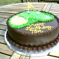 Pdr_0041.jpg 10" Chocolate cake with caramel buttercream filling, chocolate ganache frosting, IMBC grass, graham cracker and sugar sand, gumpaste...