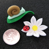 Daisies And Snails Cupcake toppers for my son's class party. Snails for the boys and flowers for the girls. They were a big hit! (Quarter for size...