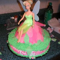 Tinkerbell Tinkerbell cake, I used the wonder mold to create the flower mound. The petals are made from fondant. the rest is buttercream.