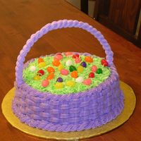 Easter Basket Handle is made of royal icing. Basketweave in buttercream. Grass is coconut, and eggs are jelly beans.