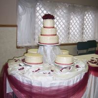 My First Wedding Cake I made this for my daughters wedding. Each layer was a different flavor and filling. Each side cake was also different flavor. I made 4...