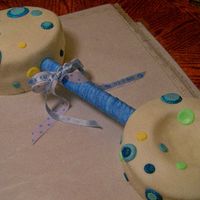 Baby Rattle This Rattle is on a full sheet size board, big end is 9" 2 layered Devils Food covered in MMF, butterecream iced'; Smaller 8"...
