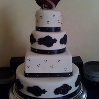 Black And White Wedding Cake White Fondant, black fondant lace. Three cake flavors. Topped with ruby red roses and black calla lillies. Fun cake to make.