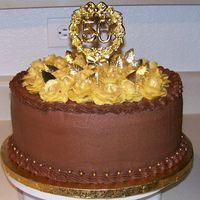 50Th Anniversay Chocolate 50th Anniversary Cake, chocolate cake, chocolate kahlua mousse filling. Gold buttercream roses topped the cake and were dusted in gold...