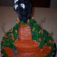 Haunted House 12 and 10 inch round cakes, wondermold on top. The castle is made of frosted plastic dowel rods and sugarcones.....trees are stems from...