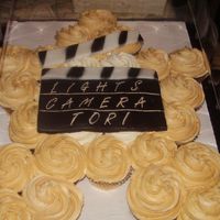 Holly Wood Super Star Shaped cupcakes in form of a star. The clap board was made out of fondent. Air brushed with black.